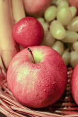 Assorted colorful fruits in basket. Apple, banana, grapes, pineapple, oranges etc. Food photography. Macro. Close-up.