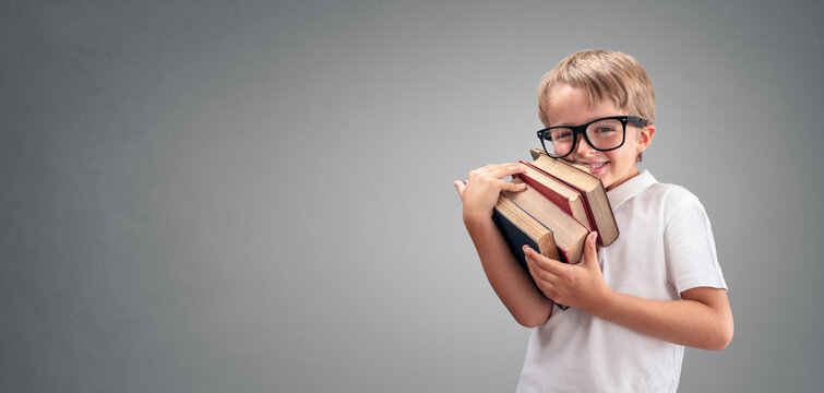 Boy holding and carrying books going back to school background