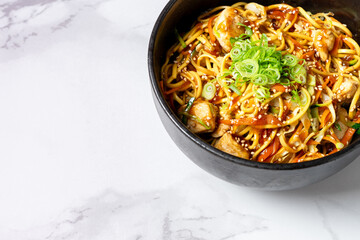 Top view of bowl with Chinese noodles with pork and vegetables. High quality photo