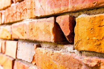 Broken red brick in an old damaged wall