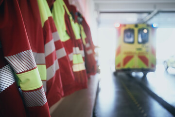 Close-up of paramedic uniforms and ambulance car of emergency medical service. Themes emergency...