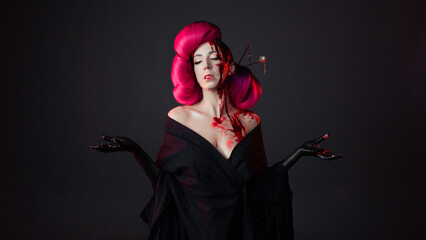 fighting geisha in a black kimono splashes blood on her face. Halloween image. young multiethnic...
