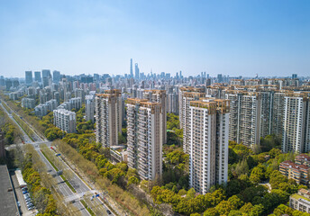 The drone aerial view of residential district in Pudong with skyscrapers in the background,...