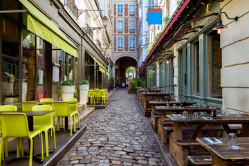 Cozy street near Boulevard San-German with tables of cafe  in Paris, France. Cityscape of Paris....