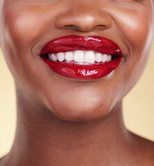 Red lipstick, woman with beauty and mouth, teeth and makeup and smile closeup isolated on studio background. Bold cosmetic product, lips and dental health, elegance and glamour with color and glow