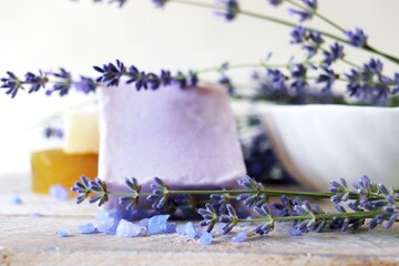 Lavender bath salt, natural soap and fresh lavender flowers on wooden background