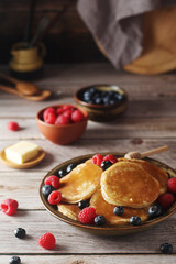 Pancakes with berries in rustic style	