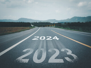 White arrow and text 2023 to 2024 on the road. Entering the new year. new beginning