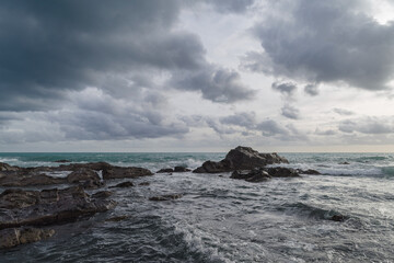 Fototapeta na wymiar Cumulus clouds hovering over the Ligurian sea, Italy
