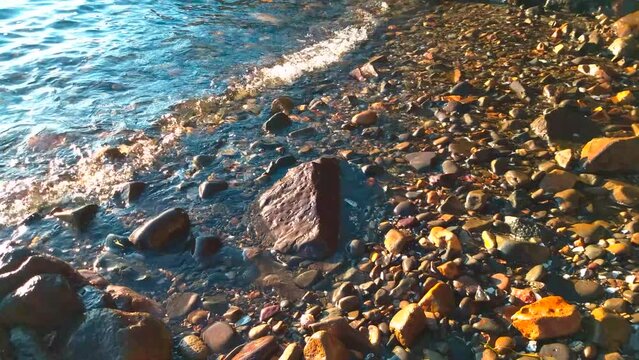 Water lapping over pebble beach shore
