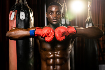 Boxing fighter posing, African American Black boxer put his hand or fist wearing glove together in...