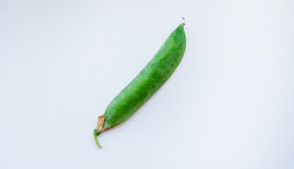 Pod of organic peas on a white background. World Vegetarian Day concept.