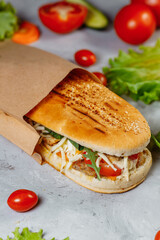 panini sandwich with crispy chicken and rucola salad