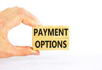 Payment options symbol. Concept words Payment options on beautiful wooden block. Beautiful white table white background. Businessman hand. Business payment options concept. Copy space.