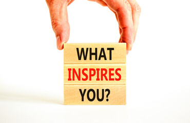 What inspires you symbol. Concept words What inspires you on wooden block. Beautiful white table white background. Businessman hand. Business motivational what inspires you concept. Copy space.