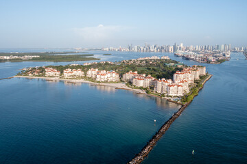 Aerial view of Fisher Island at sunrise with City of Miami skyline and Port Miami in background on...