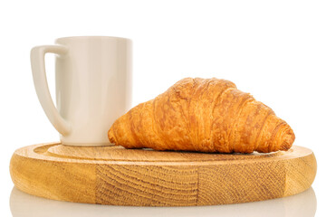 One freshly baked fragrant croissant on a wooden tray with a white cup, close-up, isolated on white.