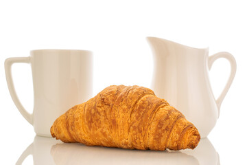 One freshly baked aromatic croissant with white ceramic dish close-up isolated on white.