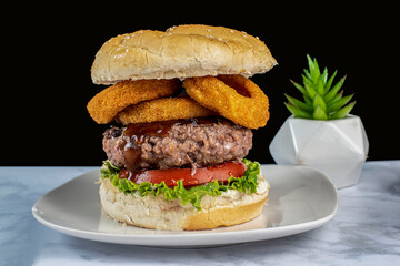 hamburger top with barbecue sauce and onion rings