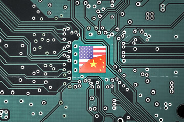Tech war between China and the USA. Flag of USA and China on a microprocessor