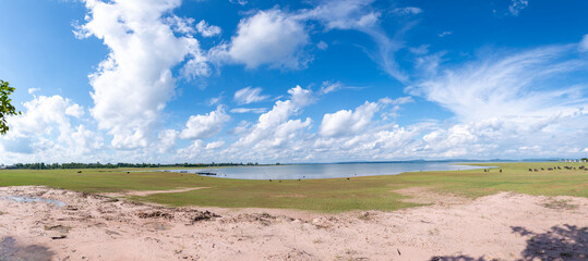 Lake, many white clouds in the blue sky