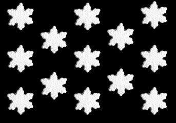 Christmas gingerbread in the form of snowflakes on the black background. Pattern. Flat lay.
