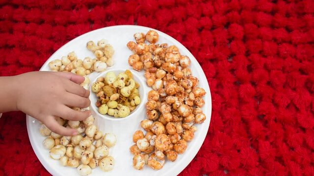 Crispy, healthy and homamade Phool Makhana or Fox Nuts snacks platter. It contain caramel makhana with jaggery, with sugar and Makhana mixture having peanut and cornflakes.	
