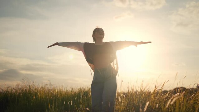 Happy smiling young woman enjoying nature. Young asian woman having fun in the meadow. freedom concept. Sunset