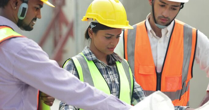 Professional Mechanical Engineer team Working on construction blueprints paper at Prefabricated concrete factory Heavy industrial. Product quality Inspection. Unity and teamwork concept