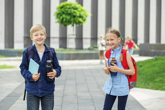 Back to school. High five. Classmates meeting. Beginning of school lessons. Reusable water bottle - Powered by Adobe