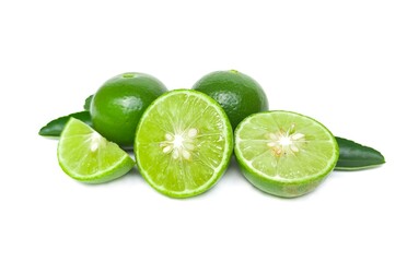 Fresh green lemons and lime leaves  placed on a white background.
