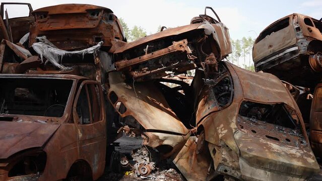 A dump of mutilated rusty cars