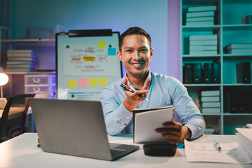 business man working late at night use laptop at desk Happy male portrait working IT, face and male...