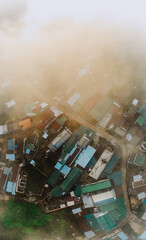created by dji camera Houses with corrugated iron roofs in the morning mist seen from above
