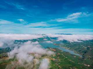 Fototapeta premium A beautiful morning with mist on top of the coffee hill in the distance is a lake in Lam Dong Vietnam