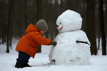 Child building a Snowman on a winters evening. Concept of playing outside in the snow and childhood. Shallow field of view.
