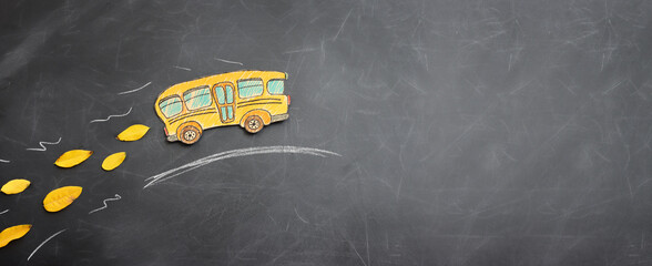 Back to school concept. bus over classroom blackboard. Top view