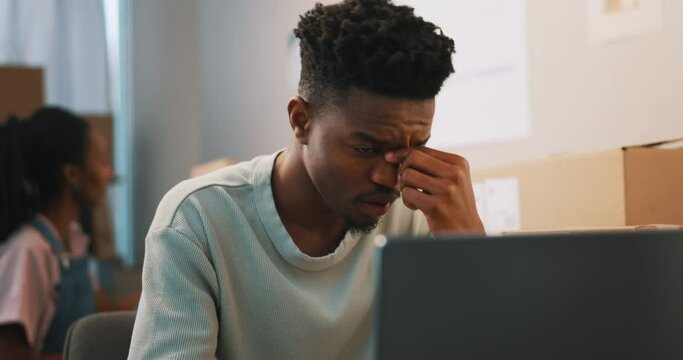 Frustrated, stress and black man on laptop in home, tired and small business fail. Burnout, fatigue and African person in financial crisis for tax, audit and anxiety for debt, depression or mistake