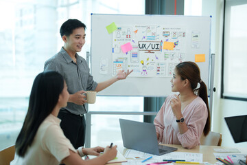 Group of asian creative teamwork discuss at business meeting for developing mobile phone app project, ux, ui start up, small business concept