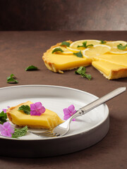 Classic lemon tart on a brown table. Copy space.