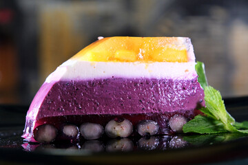 cut jelly cake with a sharp knife blueberry peach white curd cheesecake jelly preparation for the...