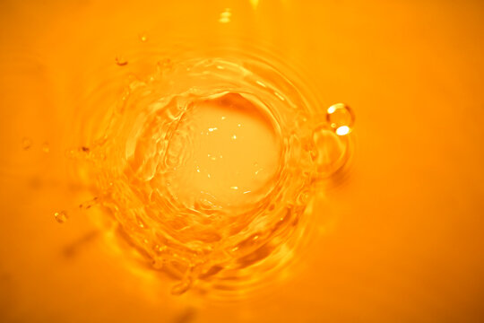 Abstract photo of water splattered in combination with orange tones.