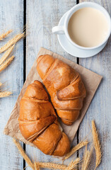 White coffee cup, croissants on wood table background. Flat lay. Top view. sweet baking dessert for coffee.