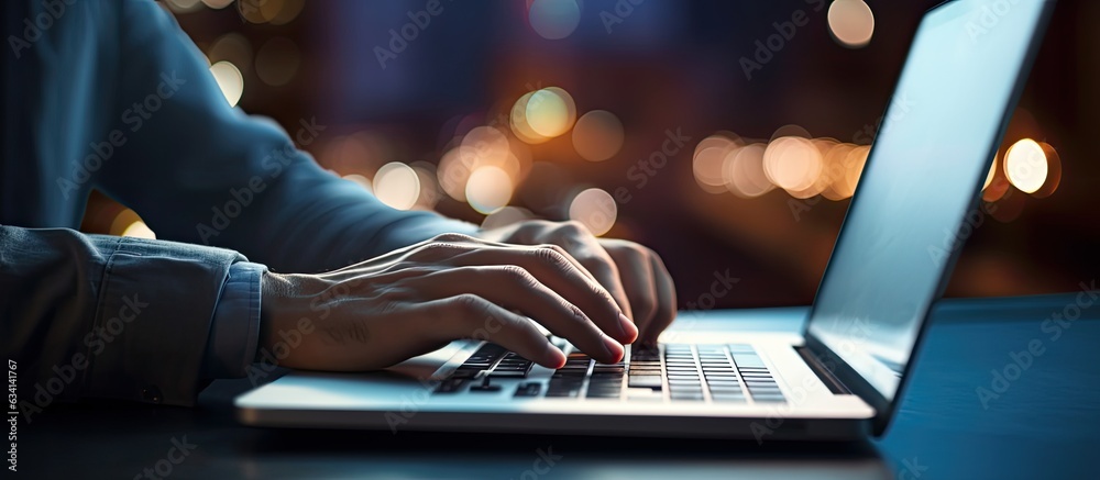Leinwandbilder young man using laptop at night with blurred bokeh background horizontal image size with space for t