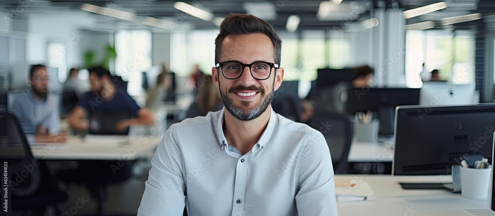 Poster Smiling male software developer at work in office ample space