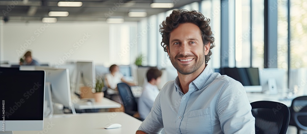 Poster Smiling male software developer at work in office ample space
