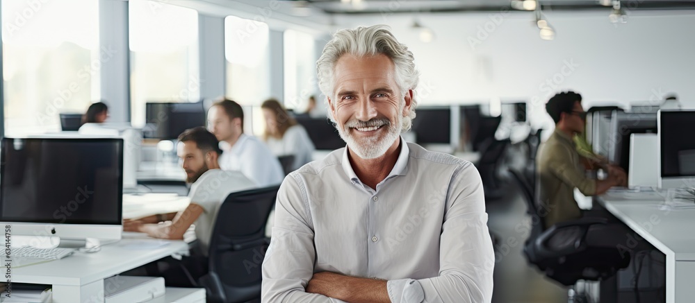 Poster smiling male software developer at work in office ample space