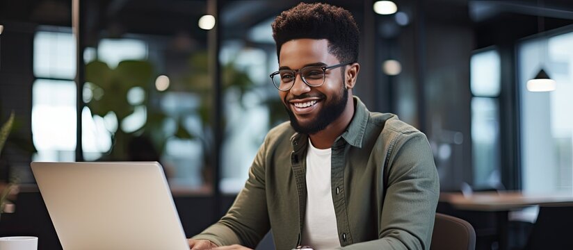 Close up of smiling African American freelancer typing on laptop enjoying remote job