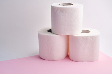 Rolls of toilet paper on a colored background. Hygiene and health concept