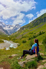 Naklejka na ściany i meble girl on the background of mountains with waterfalls